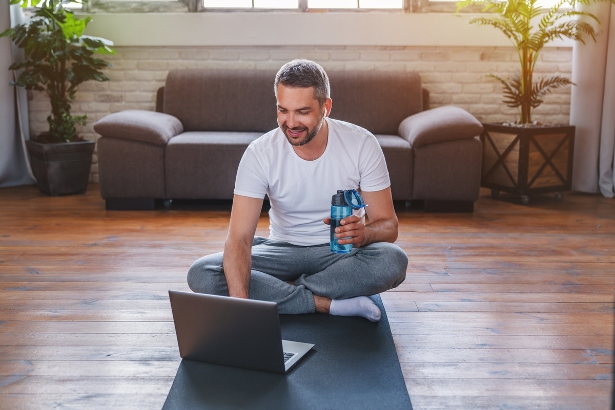 Healthy middle-aged man on an exercise mat at home, representing men exploring TRT in Medina, OH